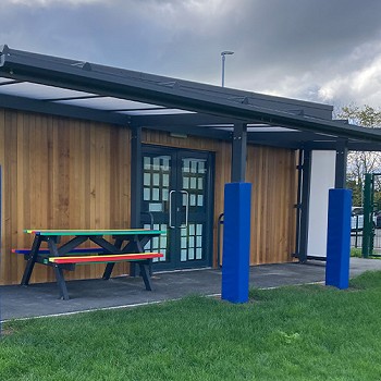 Outside area of Ysgol Cymerau with a colourful bench