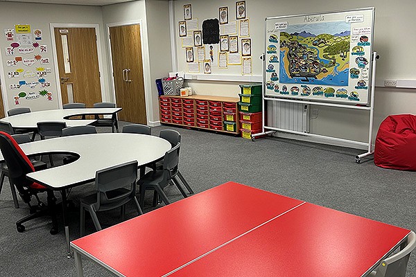 Dolgellau classroom with red tables and gray chairs