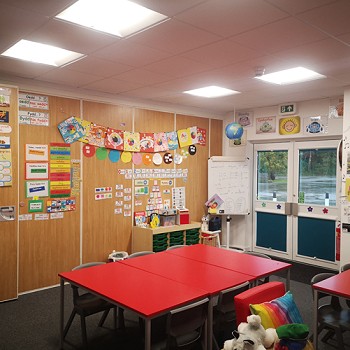 red table with chairs in a classroom
