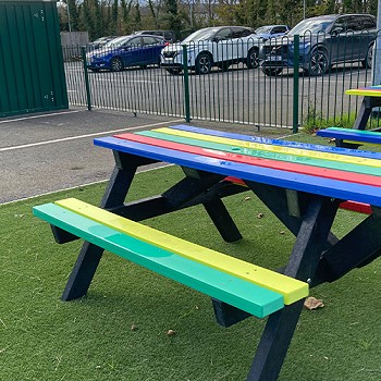 Colourful benches outside of Ysgol Cymerau